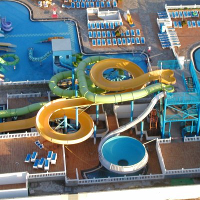 Aerial view of a water park with slides, pools, and lounge chairs.